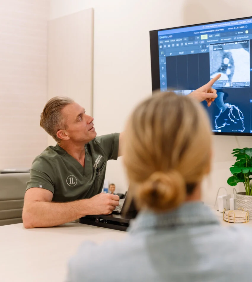 Dr. Ken Winnard reviewing imaging results with a patient at OneLife